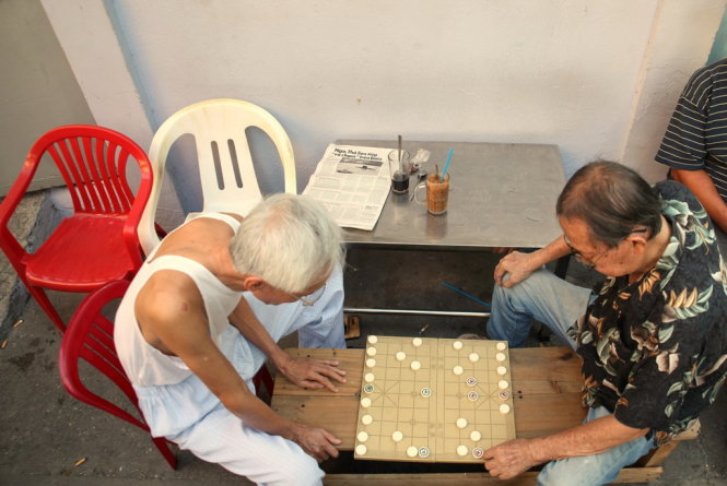 Two men play chess at a coffee shop in Ho Chi Minh City. Photo: Tam Bui - Trung Nguyen