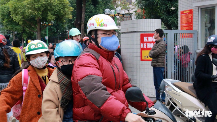 Young children are dressed in warm outfits.
