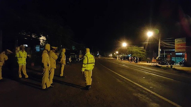 Traffic police officers block an access road into the site of the explosions at a military ammunition warehouse in Gia Lai Province. Photo: Tuoi Tre
