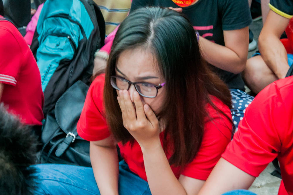 One fan lets her nerves show at the Ho Chi Minh City Youth Cultural House during Vietnam’s U23 AFC Championship semi-final against Qatar on January 23, 2018. Photo: Vu Ha Kim Vy