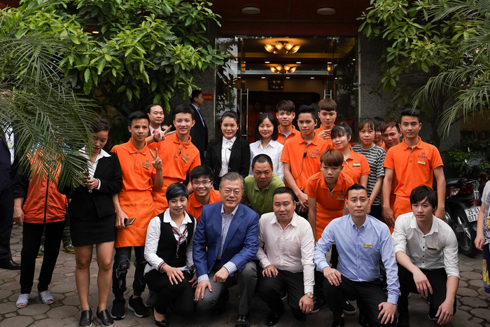 South Korean President Moon Jae-in poses with the pho restaurant attendants. Photo: Tuoi Tre