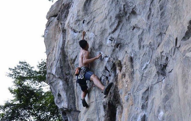 A man climbs a cliff in a photo provided by Duc Thanh.