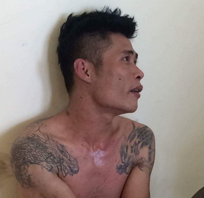 Ngo Thanh Tinh is held at the police station in this photo supplied by officers.