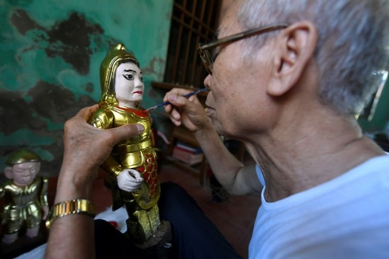 Some of the puppets weigh as much as 10 kilograms and the largest ones, like the one-metre-tall fairy, require four people to manipulate. Photo: AFP