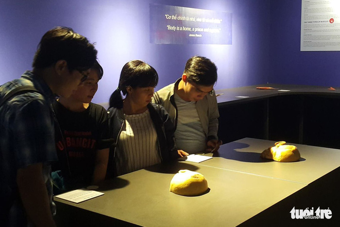 Visitors watch preserved human organs at an exhibition in Ho Chi Minh City. Photo: Tuoi Tre