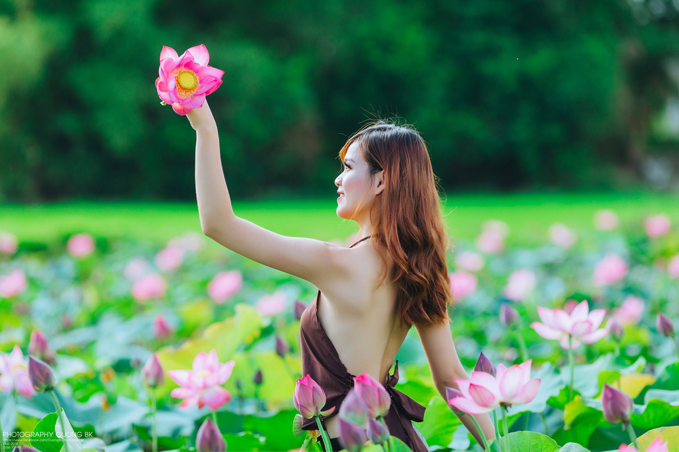 A woman in ao yem stands out amongst the lotus ‘forest’