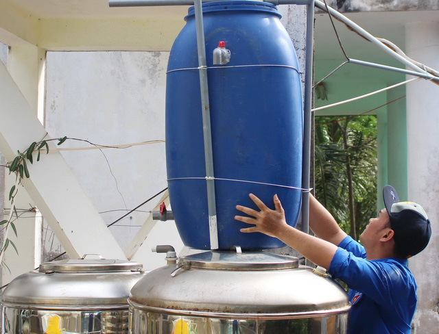 A man handles a plastic container in Vietnam. Photo: Tuoi Tre