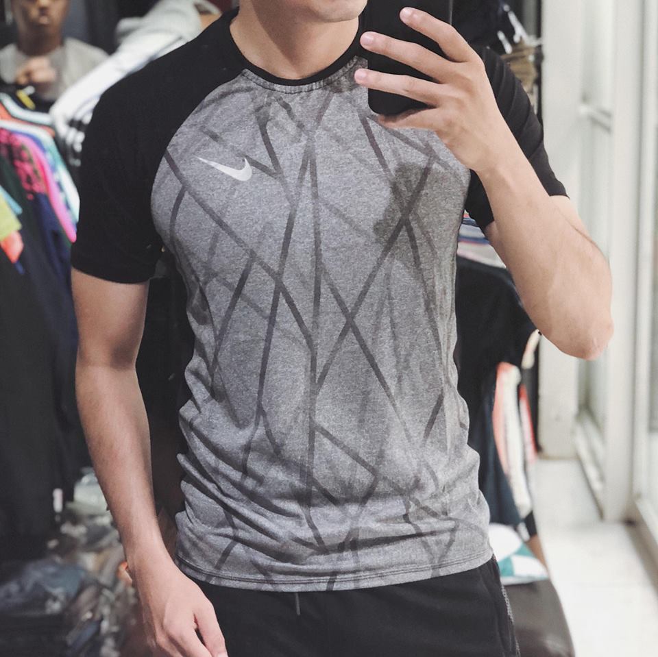 A customer shops for football jersey at a sportswear shop in Ho Chi Minh City.