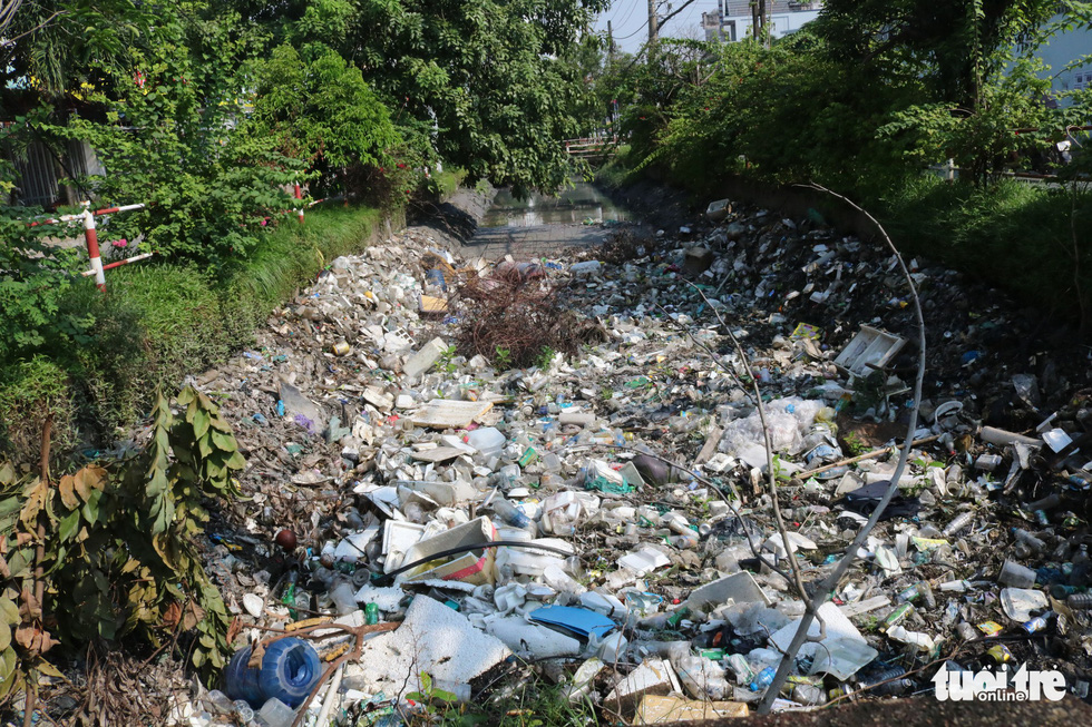 A canal in Tan Phu District is filled with trash.