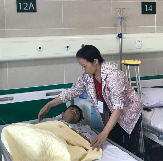 Hoang Dinh Hoanh is cared for by his mother at a hospital in northern Vietnam. Photo: Tuoi Tre
