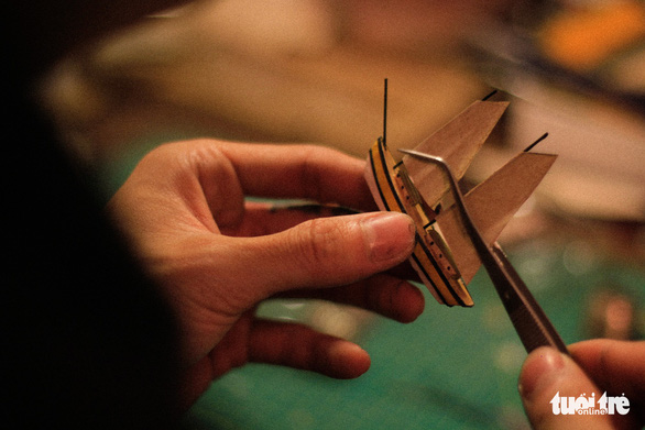 Nguyen Quang Huy makes a ship in his room in Hanoi, Vietnam. Photo: Tuoi Tre