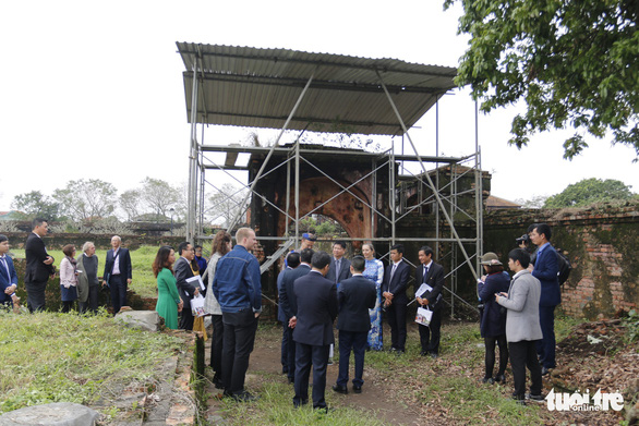 Officials stand at the vestige of a back gate at the Phung Tien temple in Thua Thien-Hue wProvince, central Vietnam, January 7, 2019. Photo: Tuoi Tre