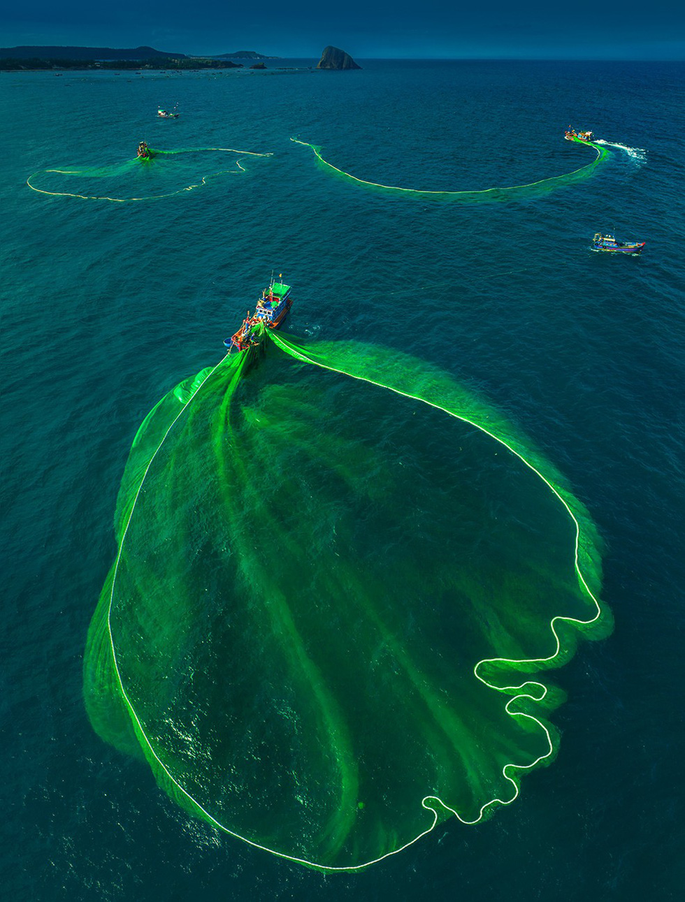 Green nets are sprung across a turquoise sea. Photo: TRAN BAO HOA