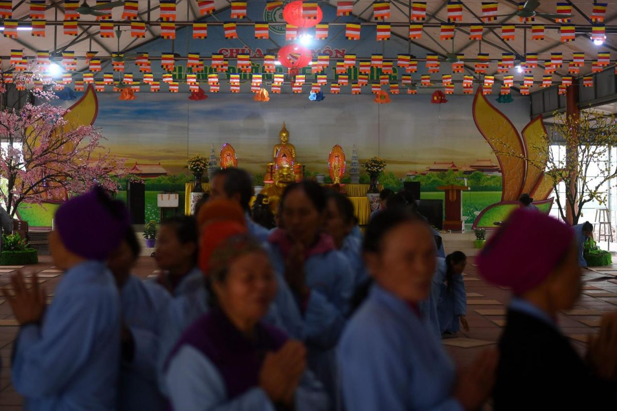 Leprosy survivors offer prayers together with villagers on the 15th day of the lunar month. Photo: AFP