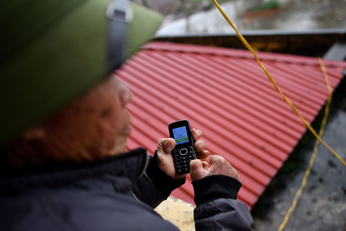 A leprosy survivor uses his mobile phone in the Van Mon Leprosy Hospice compound. Photo: AFP