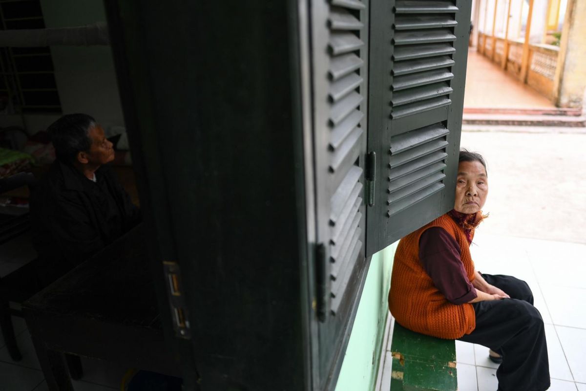 Leprosy survivors Tran Huu Hoa (left) and Nguyen Thi Teo (right) sit at the Van Mon Leprosy Hospice compound in Vietnam. Photo: AFP