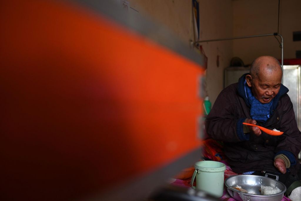 Leprosy survivor Nguyen Quang Chieu, 85, eats his lunch inside his room at the hospice. Photo: AFP