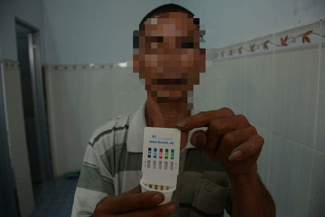 A driver holds his urine test after being stopped at a police checkpoint in Binh Thuan Province, Vietnam. Photo: Duc Trong / Tuoi Tre