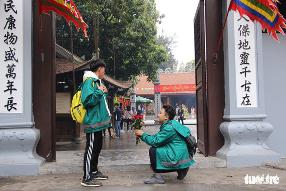 Two boys pose for a funny photo outside the Ha Pagoda in Hanoi. Photo: Ha Thanh / Tuoi Tre