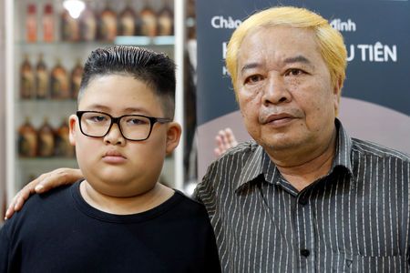 To Gia Huy, 9, and Le Phuc Hai, 66, pose after having their haircut in North Korean leader Kim Jong Un and U.S. President Donald Trump styles in a haircut salon in Hanoi, Vietnam February 19, 2019. Photo: Reuters