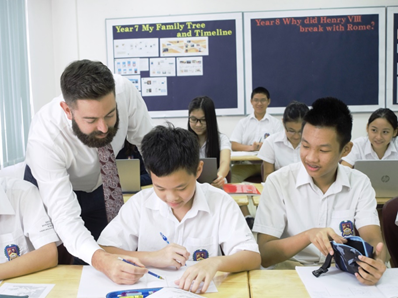  Mr Bradley Minchin (left) with his students in a history class.