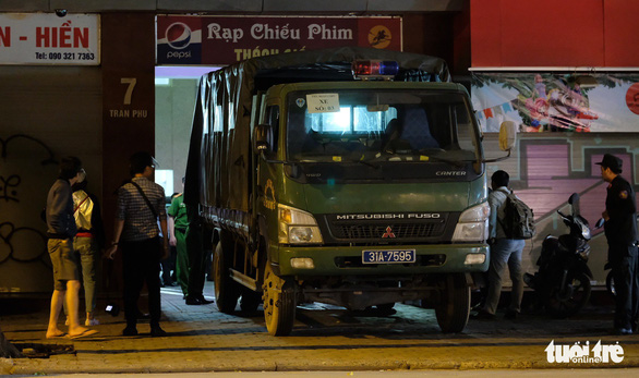 A vehicle carrying people believed to be members of Nhat Cuong Mobile leaves the company’s headquarters.  