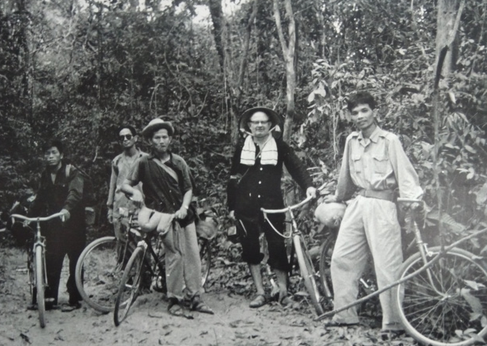 Wilfred Burchett, dressed in Vietnamese clothing, visits a revolutionary base in southern Vietnam around 1963-1964.