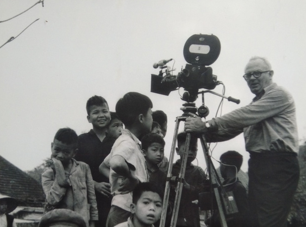 Wilfred Burchett surrounded by Vietnamese children while working in northern Vietnam in 1966.