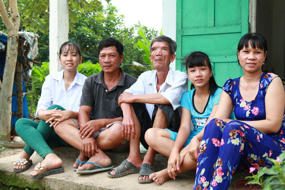Dinh Thi Kim Thuy (first on the left) sits with her family in Tra On District, Vinh Long Province, southern Vietnam. Photo: supplied