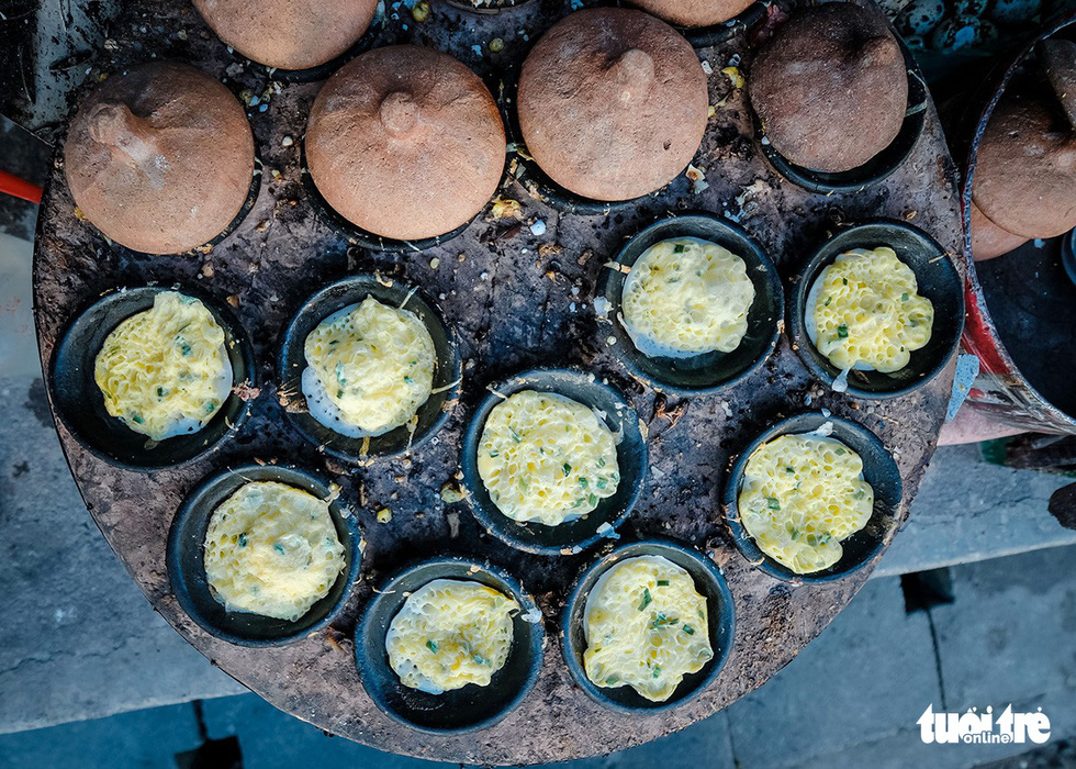  Ready to serve banh can are seen on the pan. Photo: Mai Vinh / Tuoi Tre
