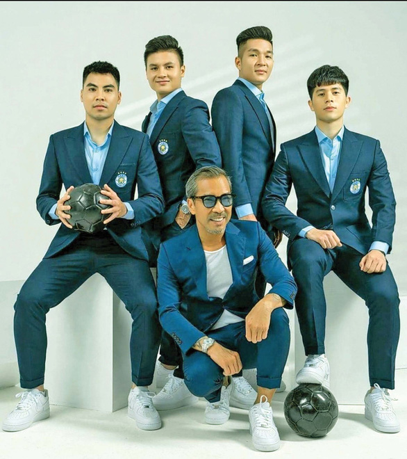 Thuan Nguyen poses for at a photo shoot with members of Hanoi’s football club, all donning suits he designed. Photo: Supplied