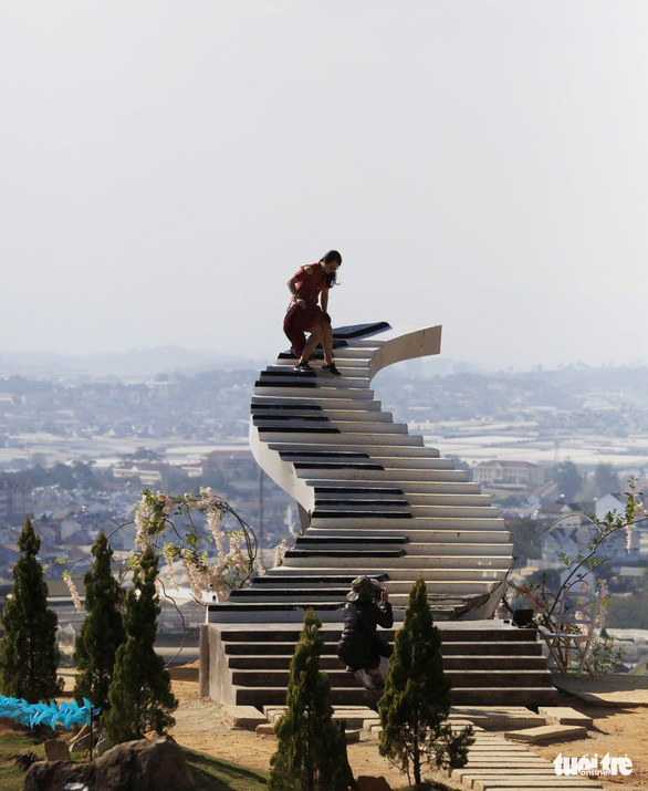 Visitors climb a staircase illegally built in Da Lat City, Lam Dong Province in Vietnam’s Central Highlands. Photo: M.Vinh / Tuoi Tre
