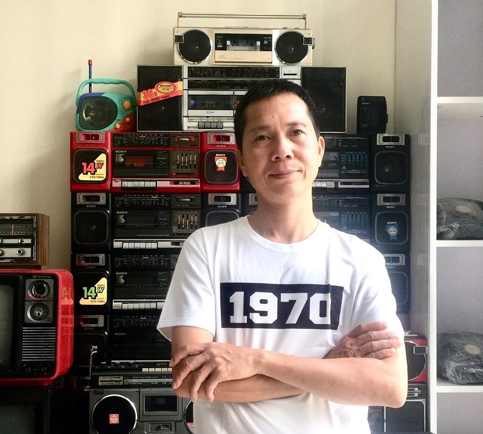 Nguyen Xuan Thuy, the president in the club of antique radio lovers, smiles in a photo taken in Hanoi with his collection. Photo: Supplied