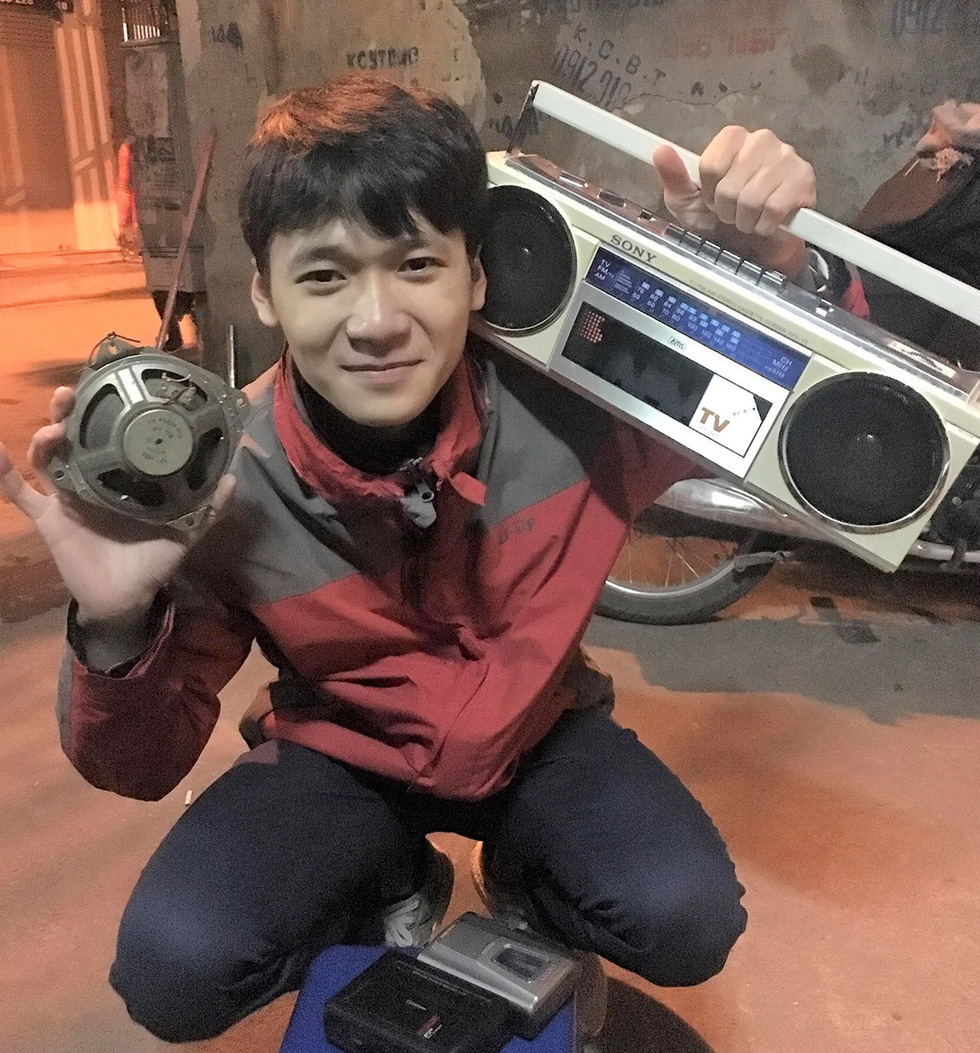19-year-old Nguyen Dung smiles for a photo while holding his antique cassette player. Photo: Supplied