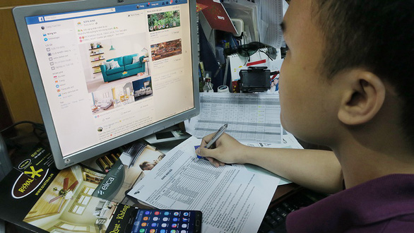 A man browses Facebook at his office in Ho Chi Minh City. Photo: T.T.D. / Tuoi Tre