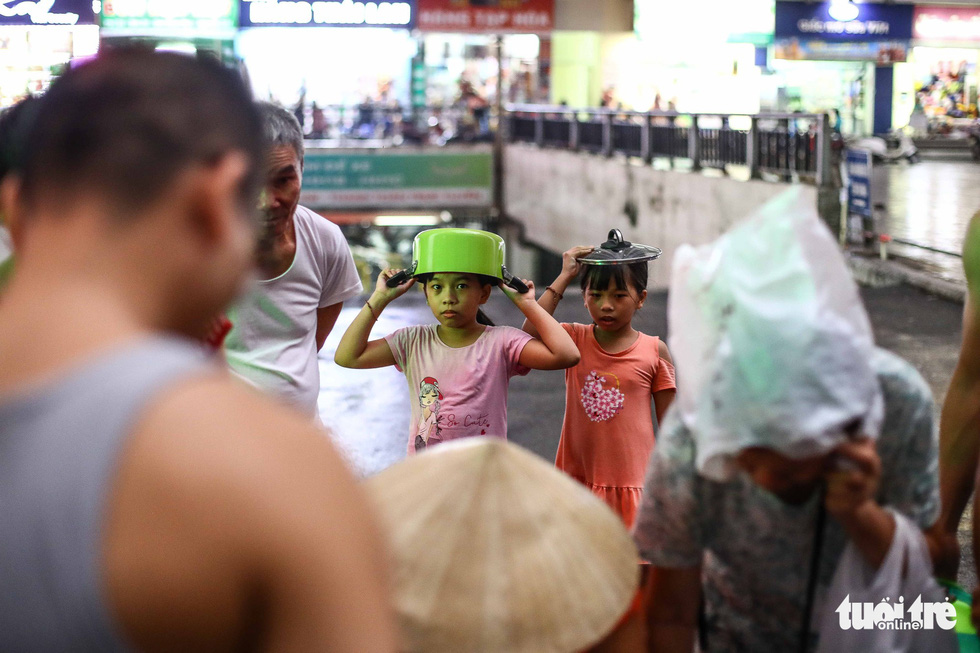 Children help their parents carry clean water in Hanoi. Photo: Nguyen Khanh / Tuoi Tre