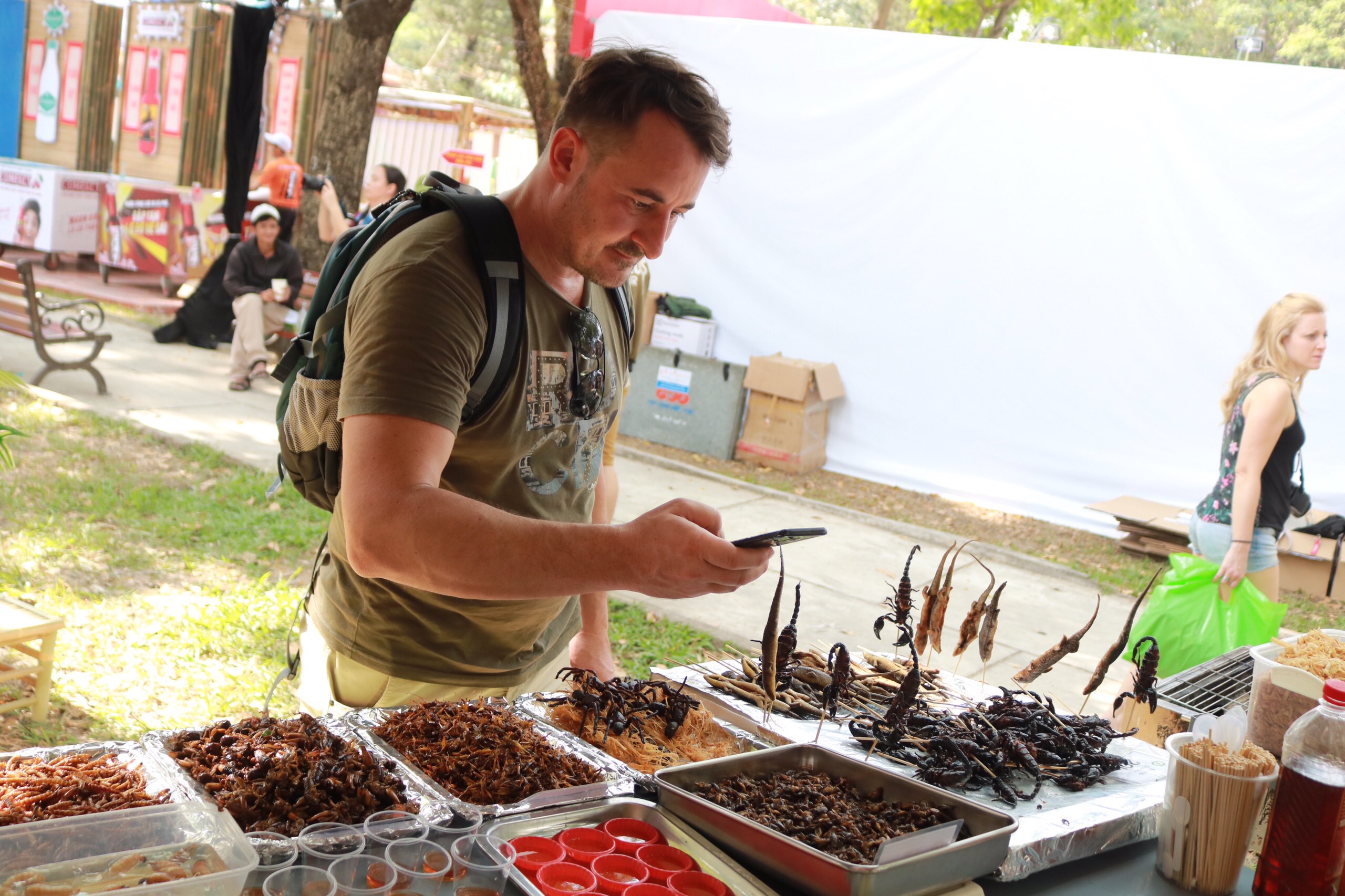 A visitor takes pictures of food made from insects at the Tet Festival 2020 at Le Van Tam Park in Ho Chi Minh City’s District 1 on January 3, 2020. Photo: Tuoi Tre News/ Ngoc Phuong