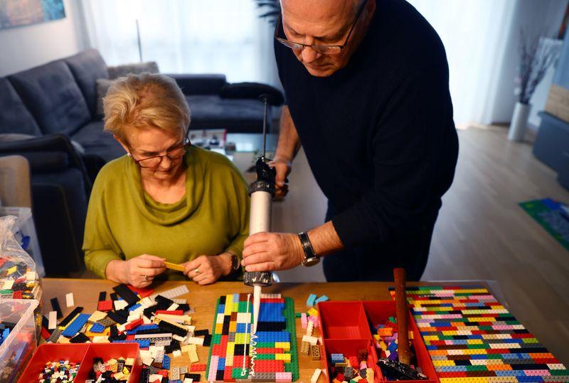 Rita Ebel (L), nicknamed 'Lego grandma,' and her husband Wolfgang build a wheelchair ramp from donated Lego bricks in the living room of their flat in Hanau, Germany, February 17, 2020. Picture taken February 17, 2020. Ebel started to build the ramps almost one year ago to raise awareness for handicapped people in her hometown of Hanau. Meanwhile, dozens of stores use the ramps to ease entry for wheelchair users.  Photo: Reuters
