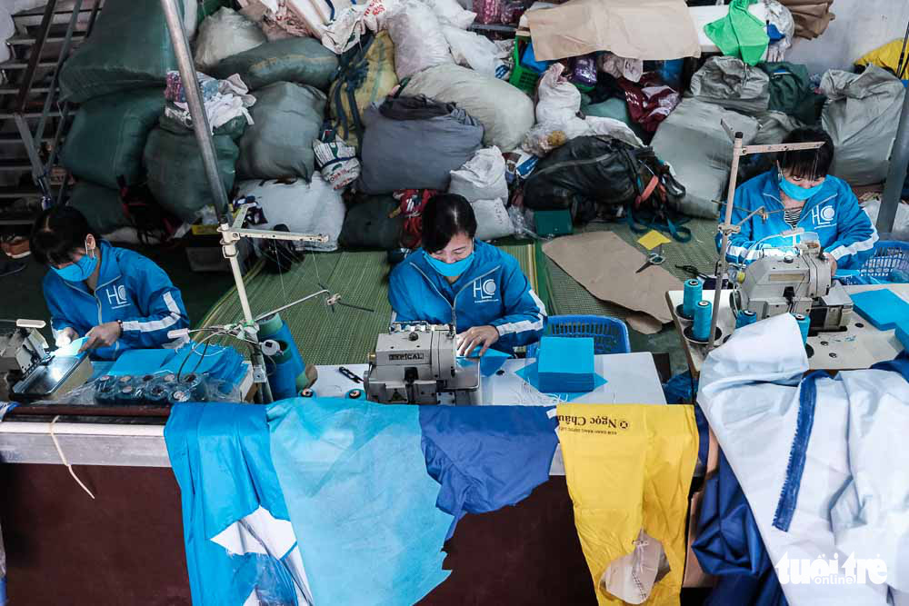 Workers produce face masks at a raincoat factory in Dong Anh District, Hanoi, Vietnam. Photo: Mai Thuong / Tuoi Tre