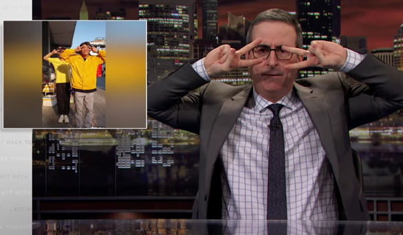 A screenshot shows host John Oliver dance to Quang Dang's Handwashing Dance on Last Week Tonight program in March, 2020.