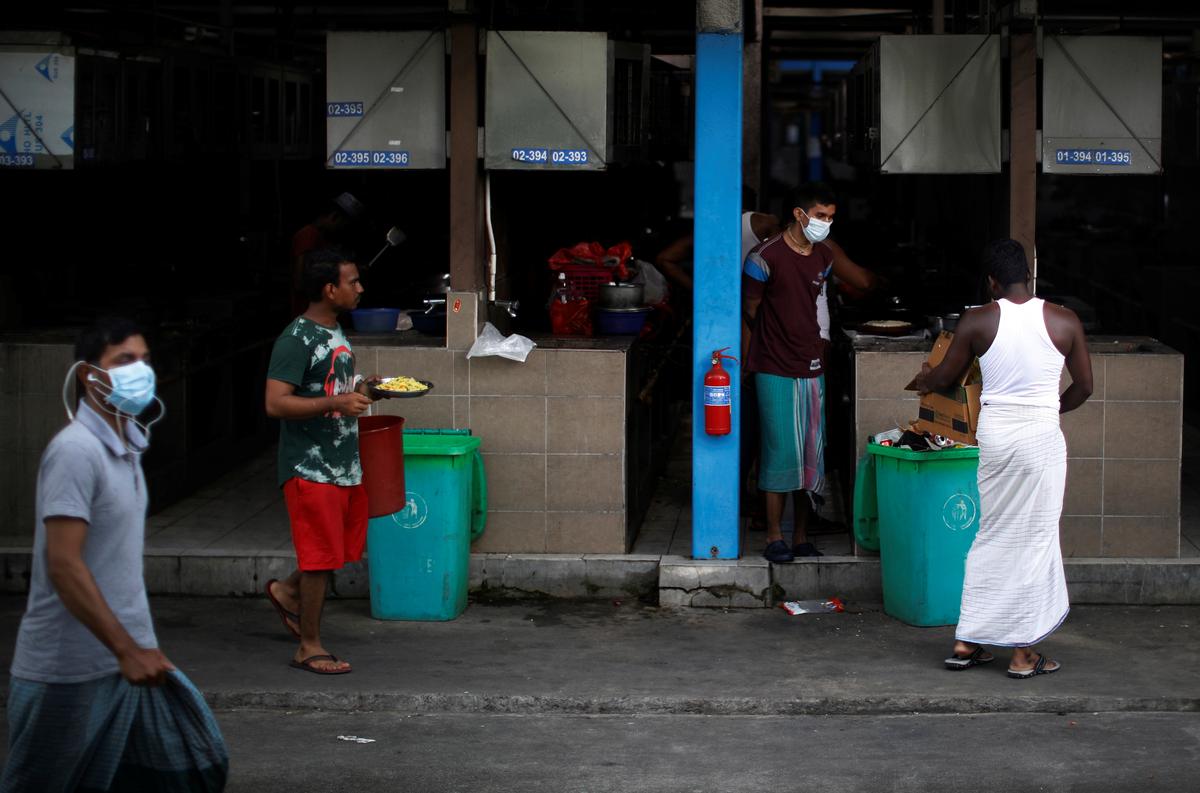 FILE PHOTO: Migrant workers are seen at S11 Punggol migrant workers' dormitory during the coronavirus outbreak (COVID-19) in Singapore April 6, 2020. Photo: Reuters