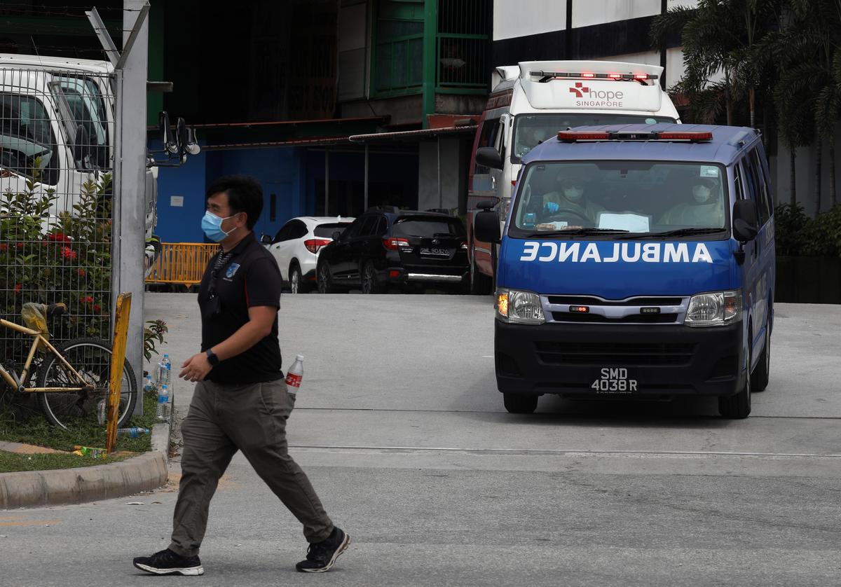 FILE PHOTO: Ambulances leave the Punggol S11 migrant workers' dormitory during the coronavirus outbreak (COVID-19) in Singapore April 6, 2020.   Photo: Reuters