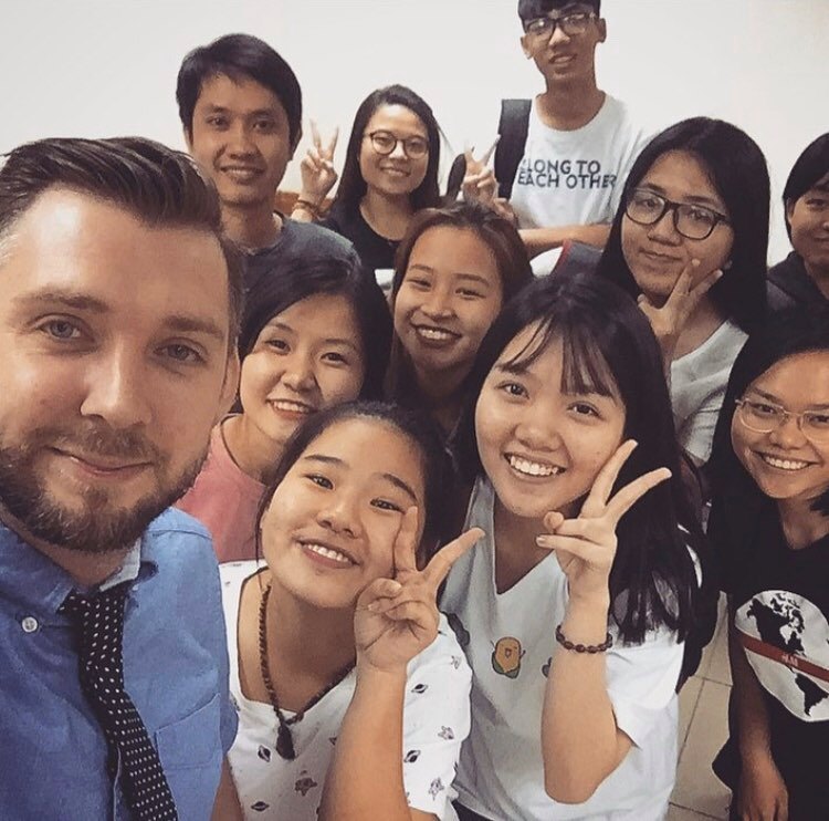 John Dewhirst (L) is seen with his students in a photo he provided Tuoi Tre News, taken before the COVID-19 causing schools and educational institutes in Vietnam to close.