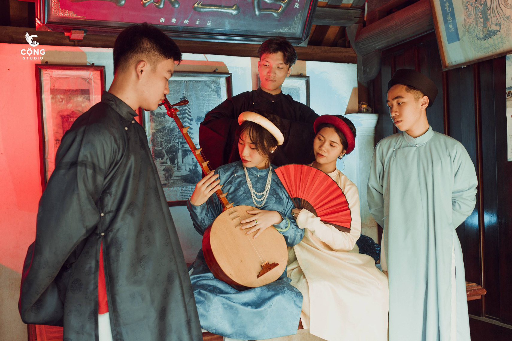 A female student holds a ‘đàn kìm,’ a traditional Vietnamese double-stringed lute, while the other students look on in this supplied yearbook photo.