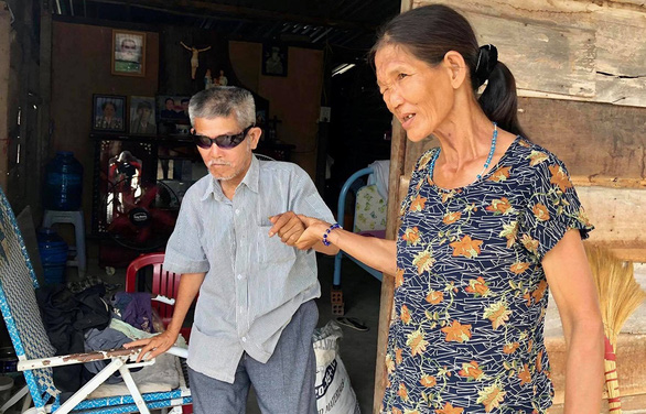Lan, 62, has only one barely working eye. She sometimes takes him for a walk around their makeshift cottage. Photo: D.Q.