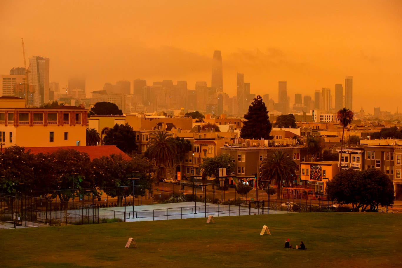 People relax under an orange smoke-filled sky at Dolores Park in San Francisco, California on September 9, 2020. Photo: AFP