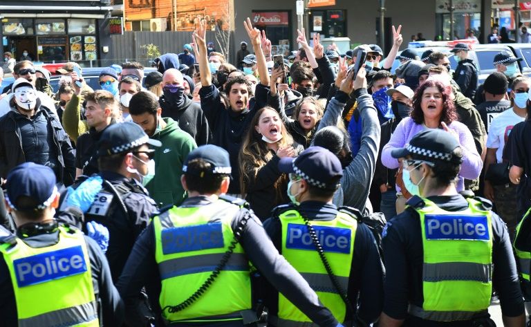 Australian police arrested dozens at an anti-lockdown rally in Melbourne on Sunday after crowds defied stay-at-home orders. Photo: AFP