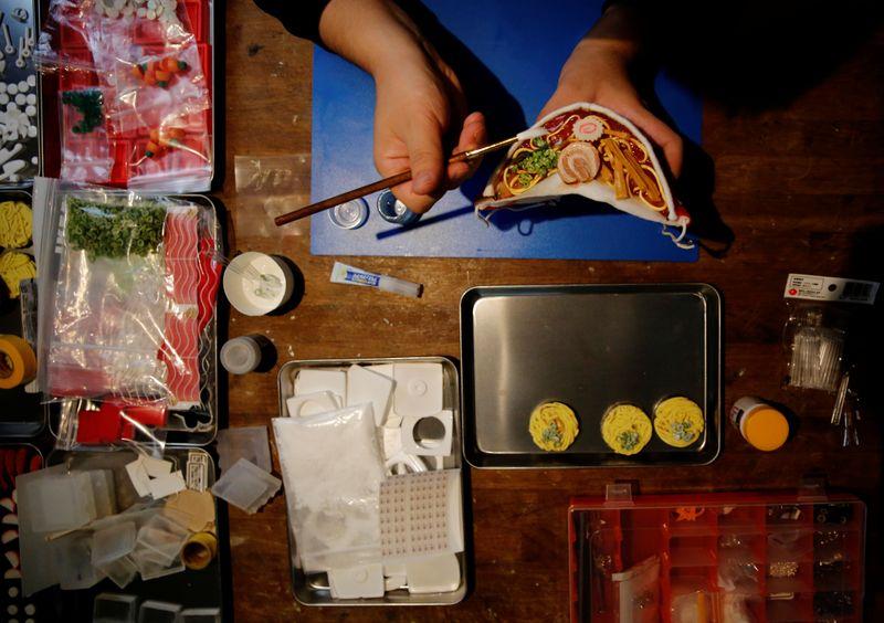 Japanese designer Takahiro Shibata's adds the finishing touches to his protective mask that looks like a steaming bowl of ramen noodle soup, following the coronavirus disease (COVID-19) outbreak, at his house in Yokohama, Japan September 23, 2020. Photo: Reuters