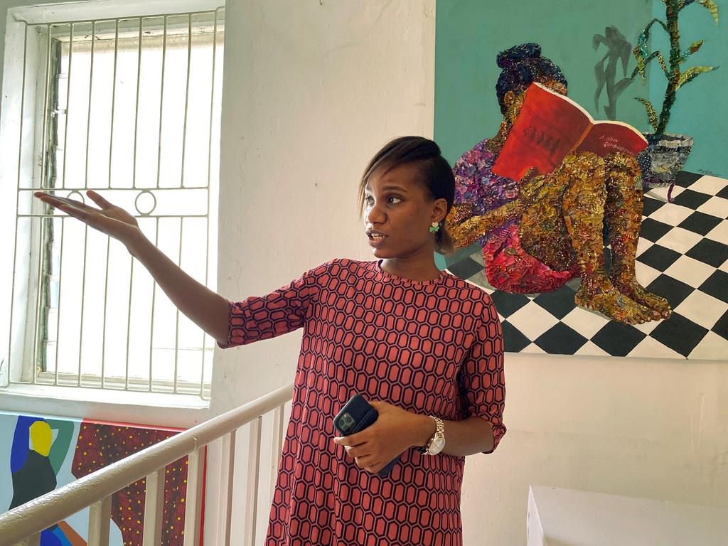Kehinde Afolabi, Associate Director of Rele Gallery gestures at an Ankara portrait at the gallery in Lagos, Nigeria August 26, 2020. Photo: Reuters
