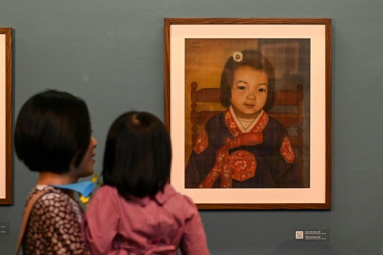Bich specialises in silk paintings of daily life and ordinary people. Photo: AFP